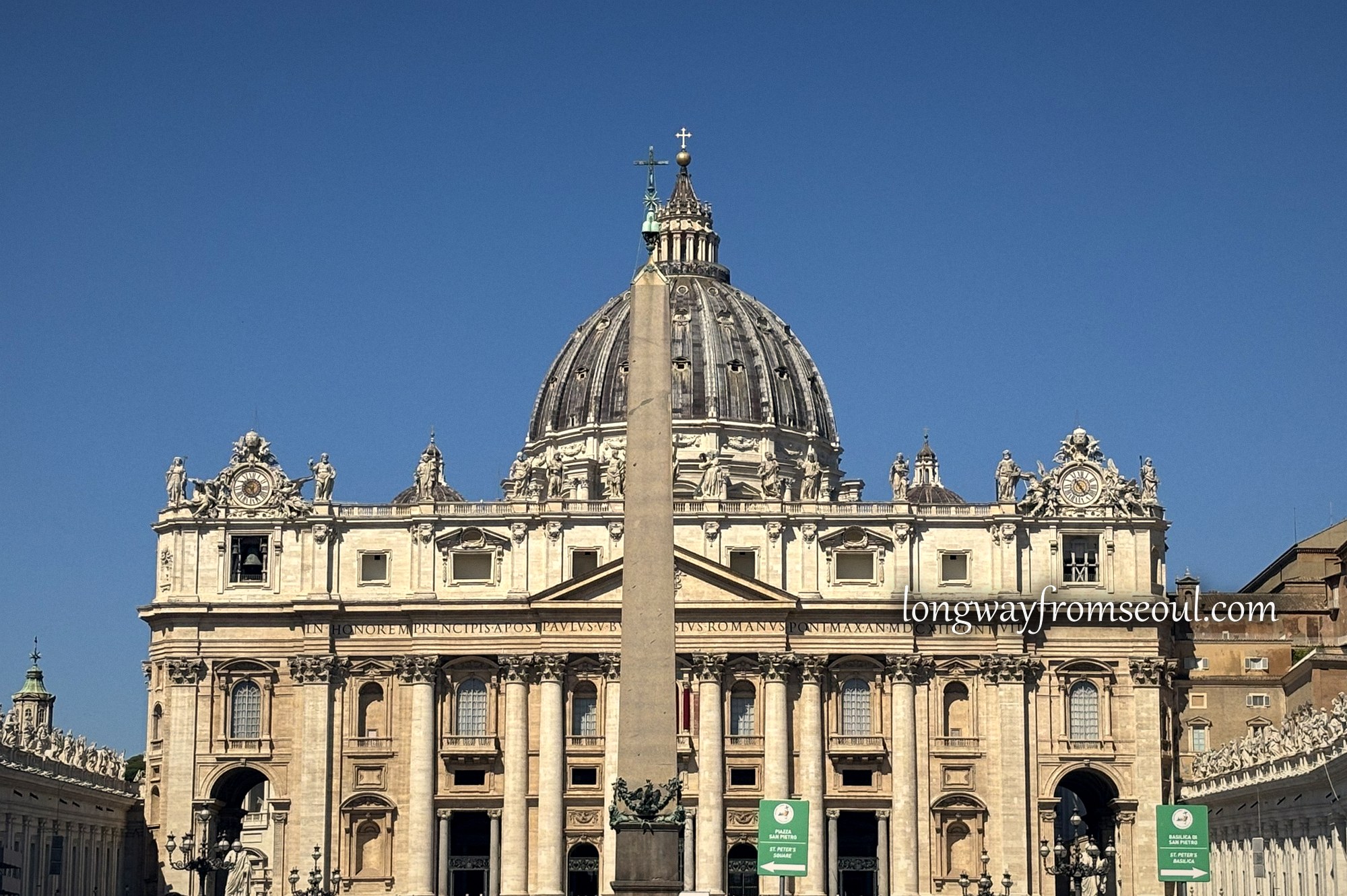 St Peter's Basilica and the Vatican obelisk under a clear sky
