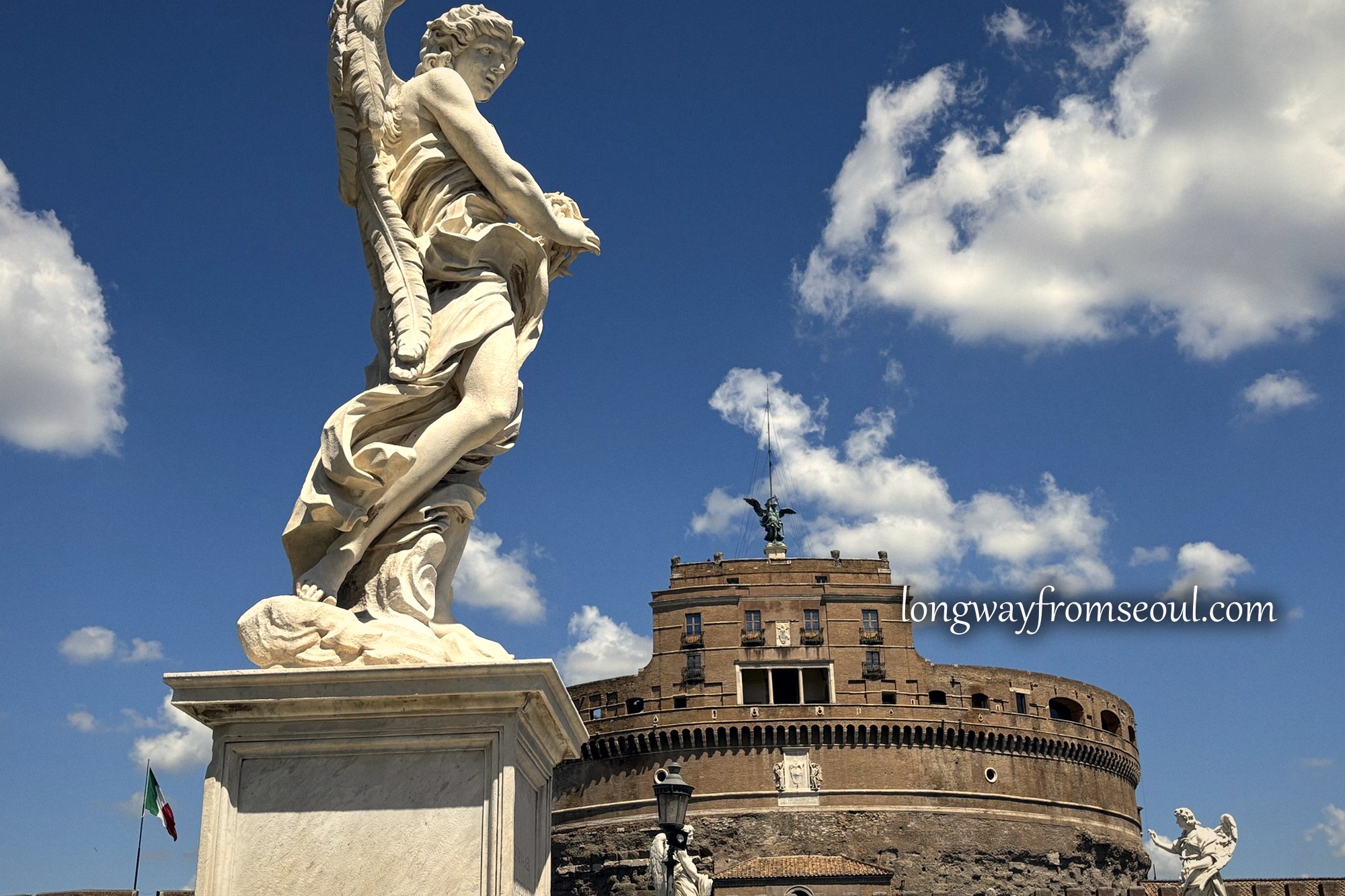 Bernini angel on Ponte Sant'Angelo with Castel Sant'Angelo behind, Rome
